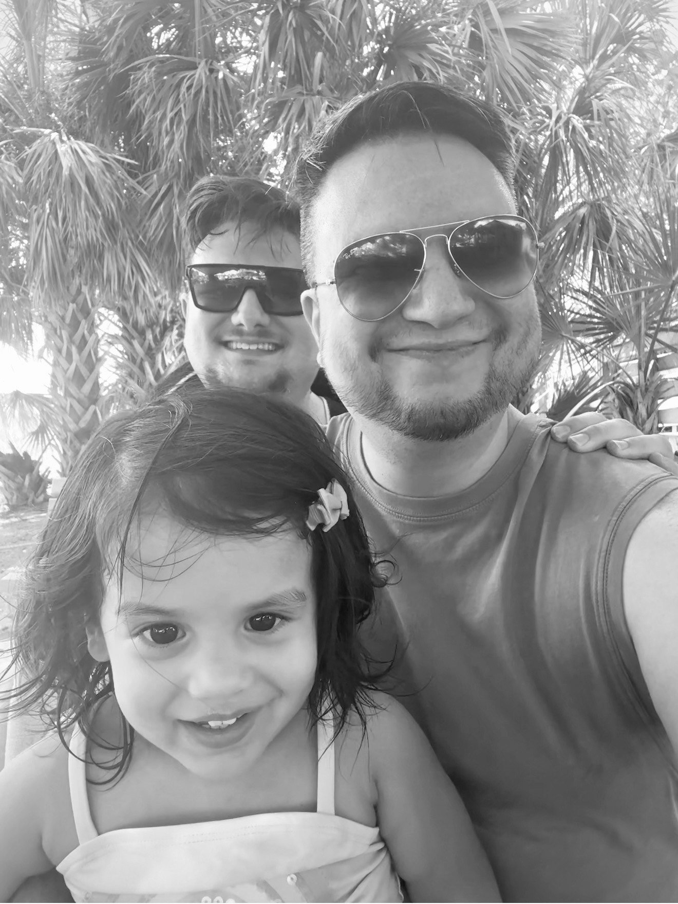 E. S. Sierra with his husband and daughter, black and white
