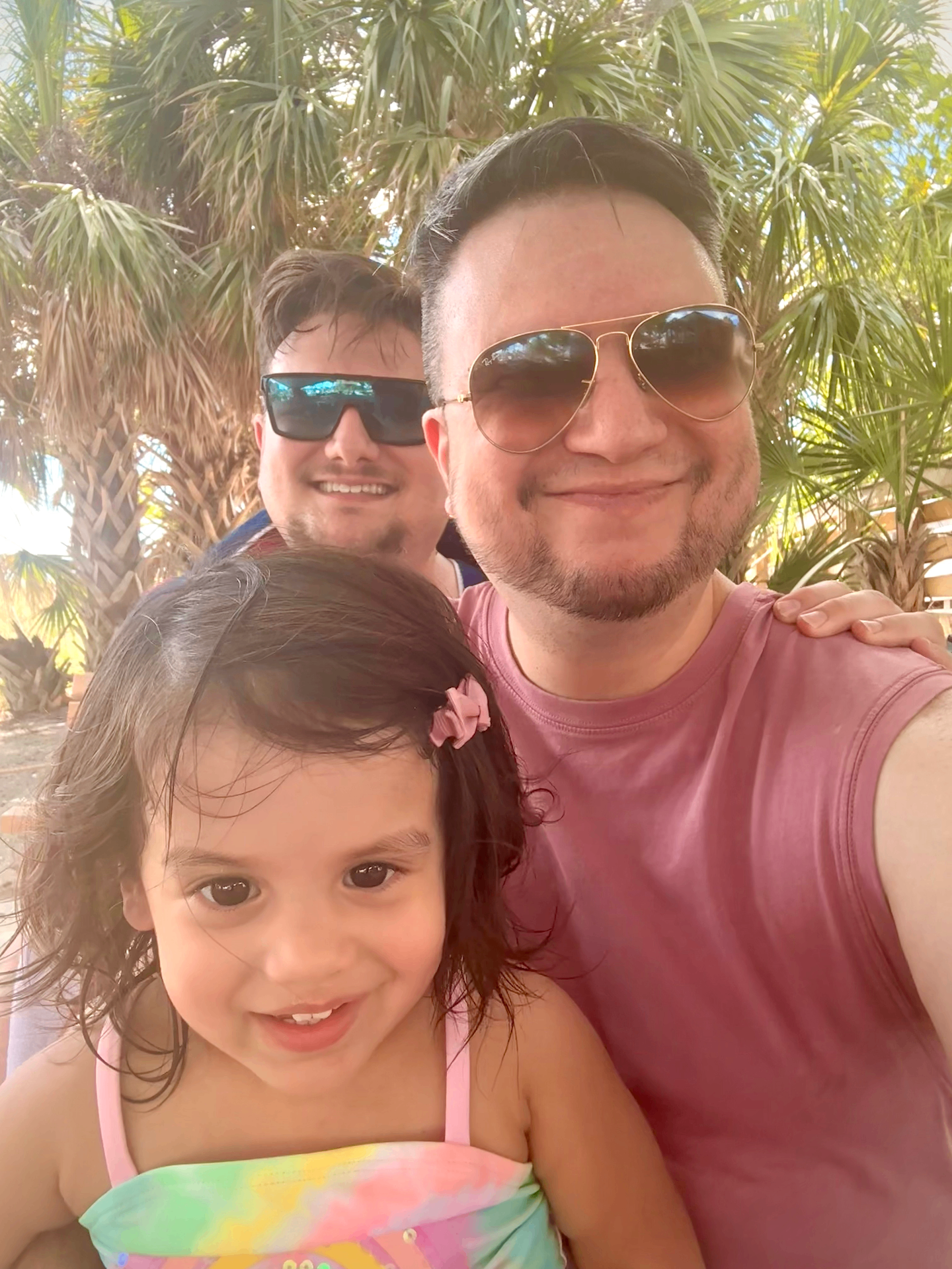 E. S. Sierra with his husband and daughter